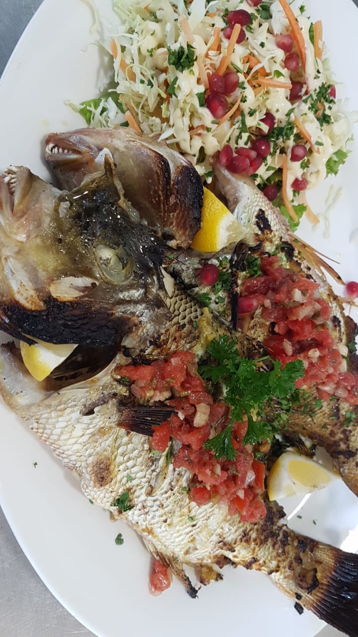 Whole freshly marinated grilled fish The Fishermanlounge